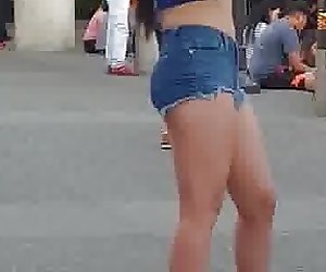 Sexy asian girl in short shorts playing on her phone